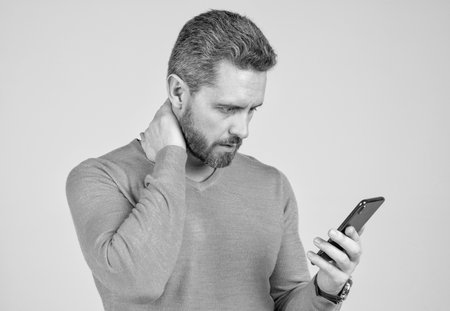concentrating on reading sms and instant messaging. sad man chat online. agile business blogging.の写真素材