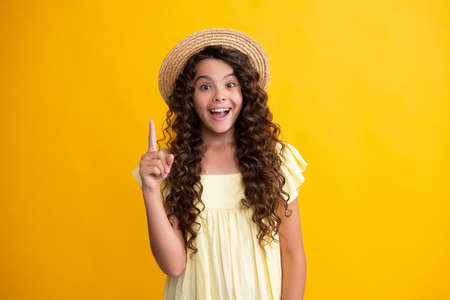 Happy teenager, positive and smiling emotions of teen girl. Young teenager pointing up with finger,...