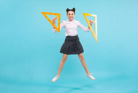 Back to school. Teenager school girl on isolated background. School supplies. Crazy jump, jumping kids. Happy teenager, positive and smiling emotions of teen schoolgirl.の写真素材