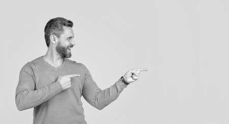 look there. mature happy guy pointing finger, copy space.