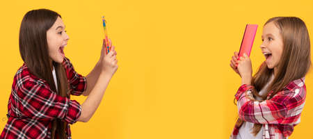 School girls friends. happy kids in casual checkered shirt having fun with notebooks, school. Banner...