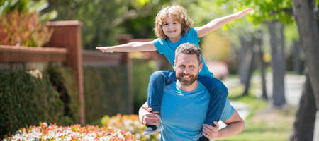 Banner of father and son walk, happy dad with son having real fun together in park, american family