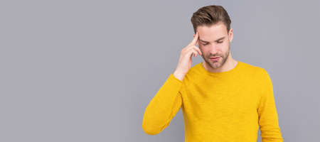 Unhappy sick man suffer from migraine attack grey background, headache. Man face portrait, banner...