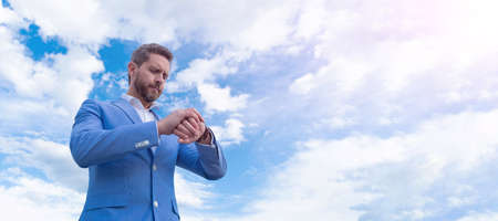 Man face portrait, banner with copy space. Business man in suit, blue sky background. handsome...