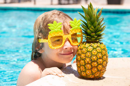 Happy child playing in swimming pool. Summer kids vacation. Little kid boy relaxing in a pool having fun during summer vacation.の写真素材