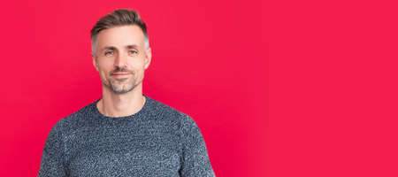 Man face portrait, banner with copy space. hair and skin care. smiling grizzled guy in sweater on...