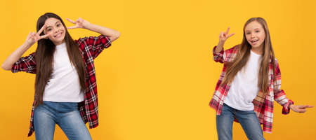 Girl friends. happy teen girls in casual shirt having fun showing peace gesture on yellow...