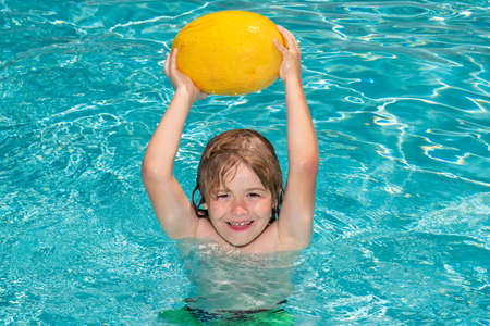 Child in swimming pool playing in summer water. Vacation and traveling with kids.の写真素材