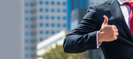 cropped businessperson with computer outside the office showing thumb up, copy space, office worker....