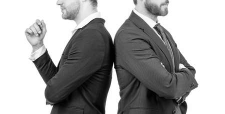 two cropped men in business suit stand back to back isolated on white, business supportの写真素材