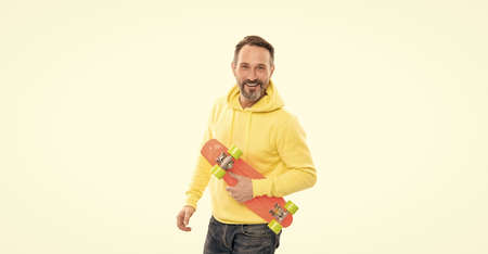 happy man skateboarder with beard hold penny skateboard isolated on white, hipster lifestyle.の写真素材