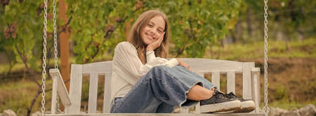 smile kid sitting on swing in park, happinessの写真素材