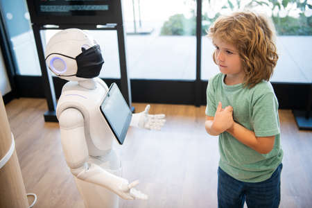 little boy interact with robot artificial intelligence, future techの写真素材