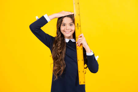 Teenager school girl study math or geometry lesson, measure the size. Mathematics ruler for measuring.の写真素材