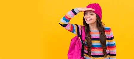 happy teen girl with backpack looking for something. back to school. Portrait of school girl student, studio banner header. School child pupil face, copy space.の写真素材