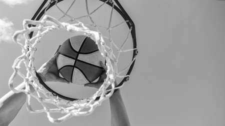 basketball ball flying through basket in players hands, copy space, targetingの写真素材
