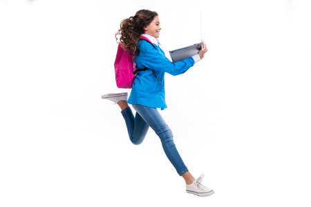 Run and jump, jumping kid. Schoolgirl in school uniform with laptop. Schoolchild, teen student on...