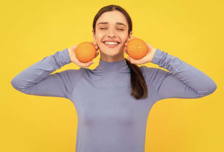 health by natural organic fresh grapefruit. diet and skin beauty. happy girl with orangeの写真素材