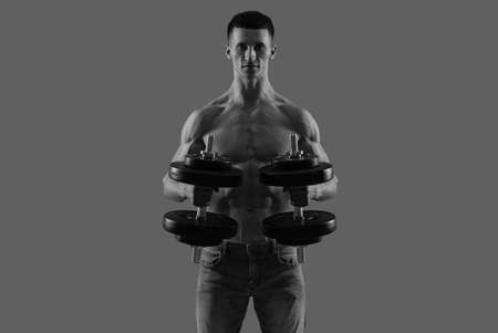 For arm strength. Shirtless man do dumbbell workout. Strength exercisesの写真素材