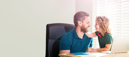 Banner of teacher and pupil school boy with laptop at home, back to school. loving daddy and son in glasses use computer at home. family blog.の写真素材