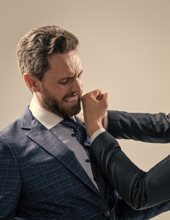 Professional man employee got punch in face with fist grey background, conflictの写真素材