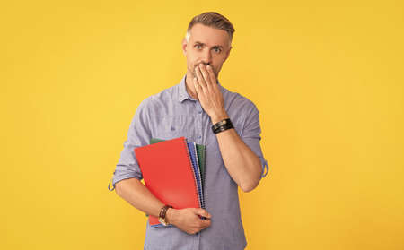 confused guy with documents in clipboard. signing a contract. school teacher or university tutor