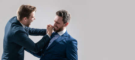 Man face portrait, banner with copy space. two angry businessmen punching in fight and arguing...