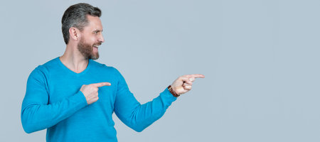 Man face portrait, banner with copy space. look there. mature happy guy pointing finger, copy space.