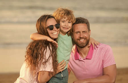 happy family of mother father and child on summer beachの写真素材