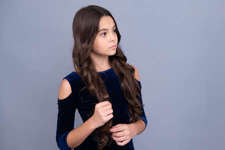 Children studio portrait on gray background. Childhood lifestyle concept. Cute teenage girl face close up.の写真素材