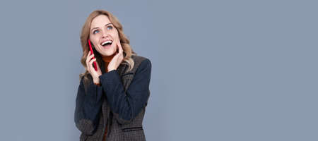 happy business woman in checkered english jacket speak on phone, communication. Woman portrait, isolated header banner with copy space.の写真素材