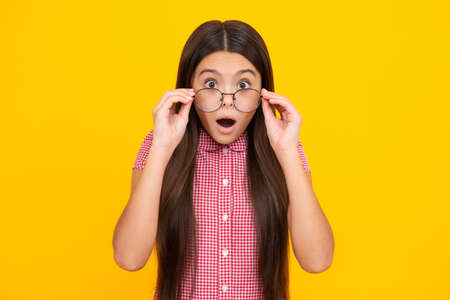 Shocked surprised teenager girl. Portrait of teenager child girl in glasses. Kid at eye sight test....