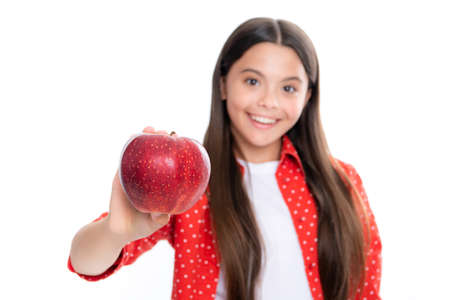 Fresh fruit. Teenager girl hold apples on white isolated studio background. Child nutrition. Portrait of happy smiling teenage child girl.の写真素材