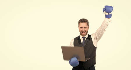 happy man in boxing gloves hold laptop isolated on white background, copy space, championship.の写真素材