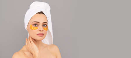 Eye patches, patch under eyes. shine future. skincare. facial collagen cosmetic. moisturizing skin. cosmetology. young woman. Beautiful woman isolated face portrait, banner with mock up copy space.の写真素材
