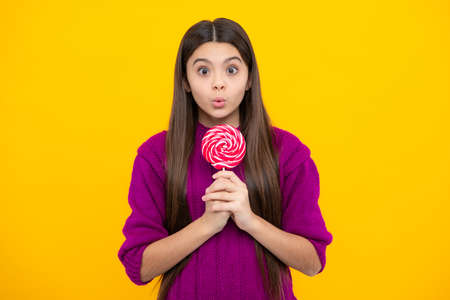 Teenage girl with lollipop, child eating sugar lollipops, kids sweets candy shop. Excited teenager...