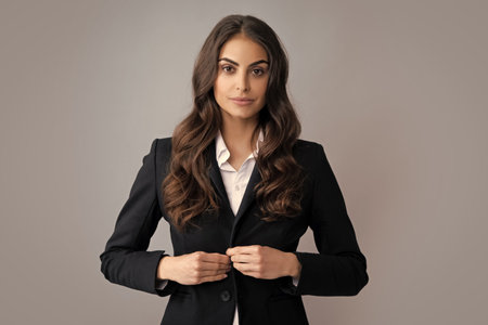 Portrait of successful business woman in suit on gray isolated background. Serious office female worker, manager employees. Female employee young secretary.の写真素材