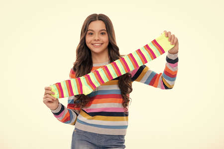 Teen hold strip sock on white background. Child holding a pair of stripped socks.