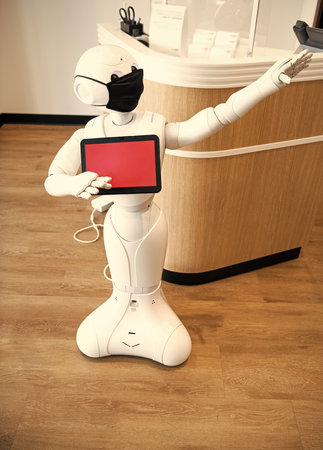futuristic robot assistant innovative technology in protective mask. presenting or directingの写真素材