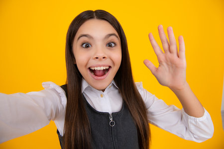 Teenager lifestyle. Beautiful ateenager child girl in moder suit making selfie posingisolated on...