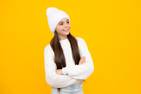 Teenager kid crossed arms with confidence isolated on yellow. Confident teen child girl crossed...