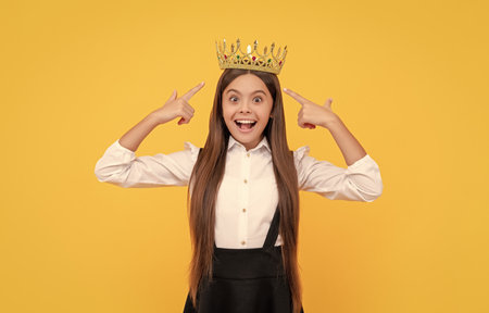 proud teen girl smiling. egoistic child wear diadem. arrogance and selfishness.の写真素材