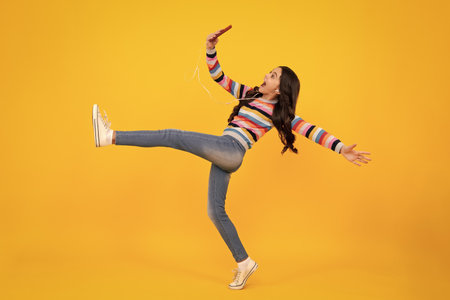 Kids selfie. Mobile online shopping. Cute teen child girl paying with phone, texting and chatting on smartphone. Shocked amazed face, surprised emotions of young teenager girl.の写真素材