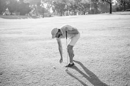 man playing game on green grass taking ball. summer activity. professional sport outdoor
