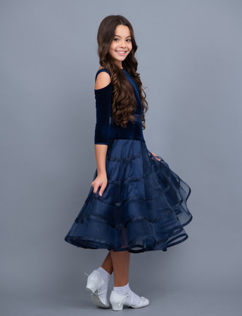 Full length of teenager child wearing ball dress. Happy girl face, positive and smiling emotions.の写真素材