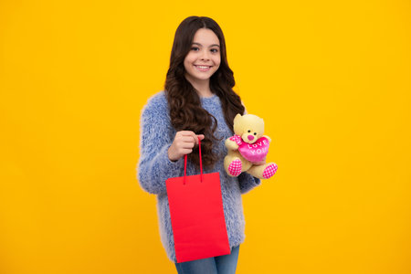 Teenager hold shopping bag enjoying sale. Child girl is ready to go shopping. Happy teenager, positive and smiling emotions of teen girl.の写真素材