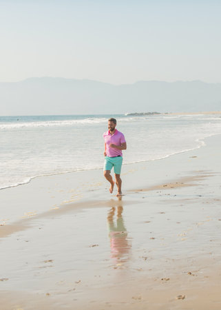 smiling sport athlete run fast to win in the ocean. morning workout activity.の写真素材