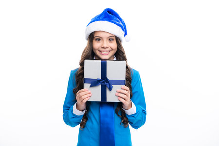 Teenager child girl holding present box isolated over white studio background. Present, greeting and gifting concept. New Year or Christmas holiday concept.の写真素材