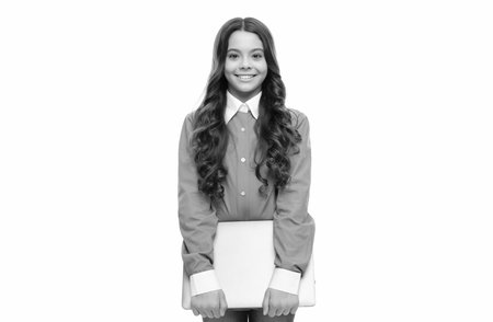 happy face of teen girl with long curly hair hold computer isolated on white, schoolの写真素材