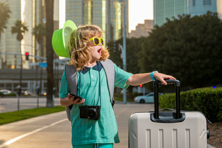 Traveler tourist kid boy 7-8 years old. Passenger traveling abroad to travel on weekends getaway. Independent kid boy with big travel bag.の写真素材